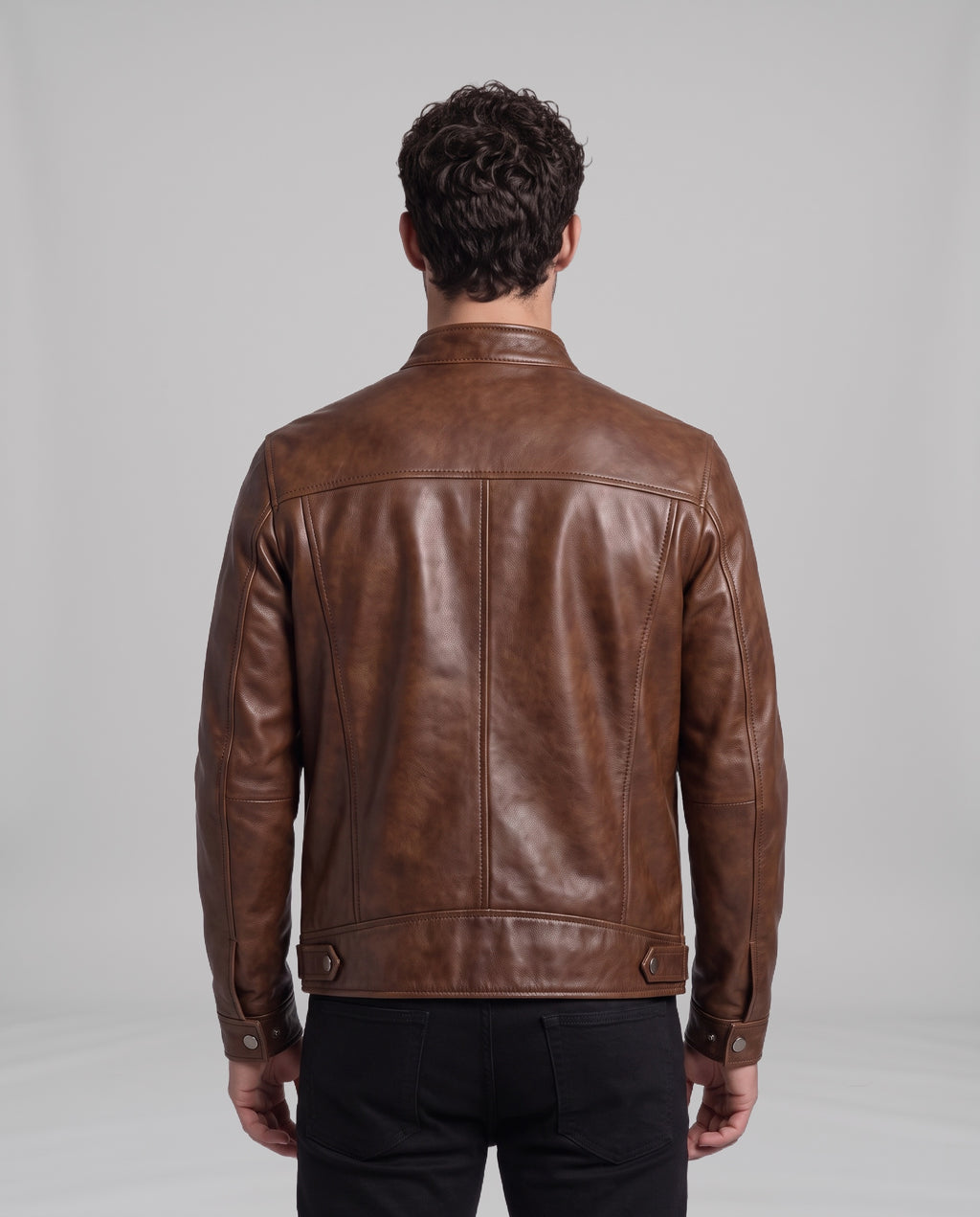 Back view of the Garrett vintage leather jacket in Cigar Brown showing shoulder yoke, panel seams and waistband snap tabs