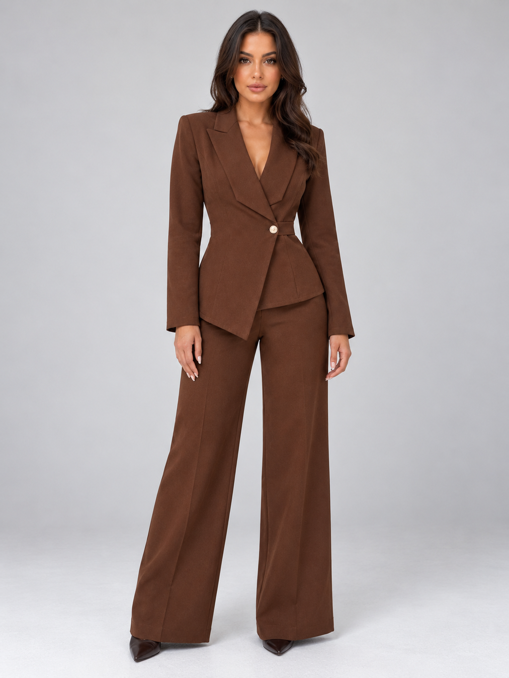 Woman wearing brown belted blazer with wrap front and matching wide leg trousers, styled as a tailored two-piece suit