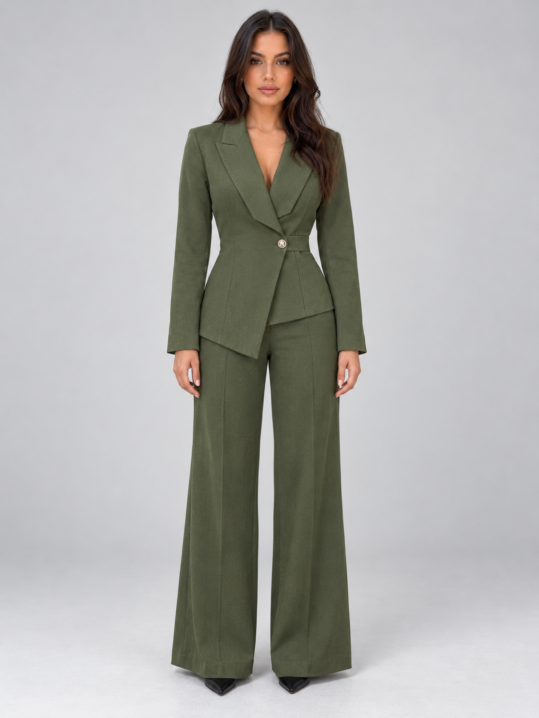Woman wearing olive green belted blazer and wide leg trousers tailored two-piece suit with black pointed toe shoes