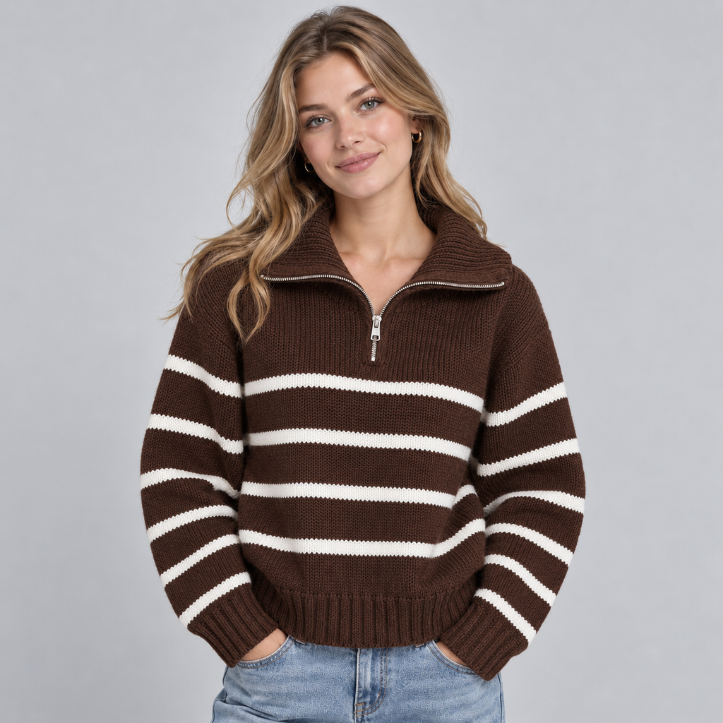 Woman wearing brown and white striped half-zip funnel neck jumper with ribbed collar over light blue jeans