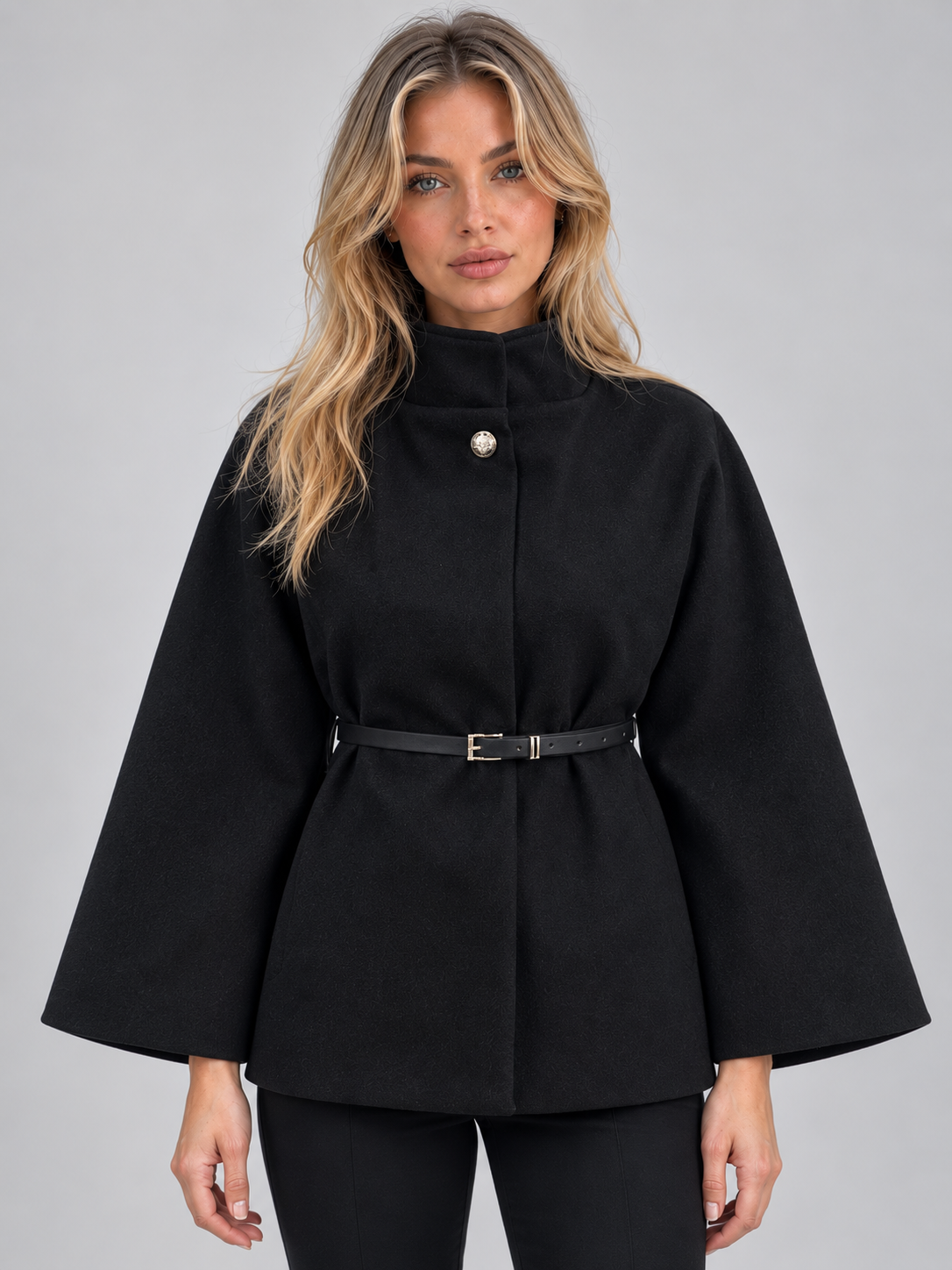 Women's black high neck belted cape jacket with flared sleeves and single button closure