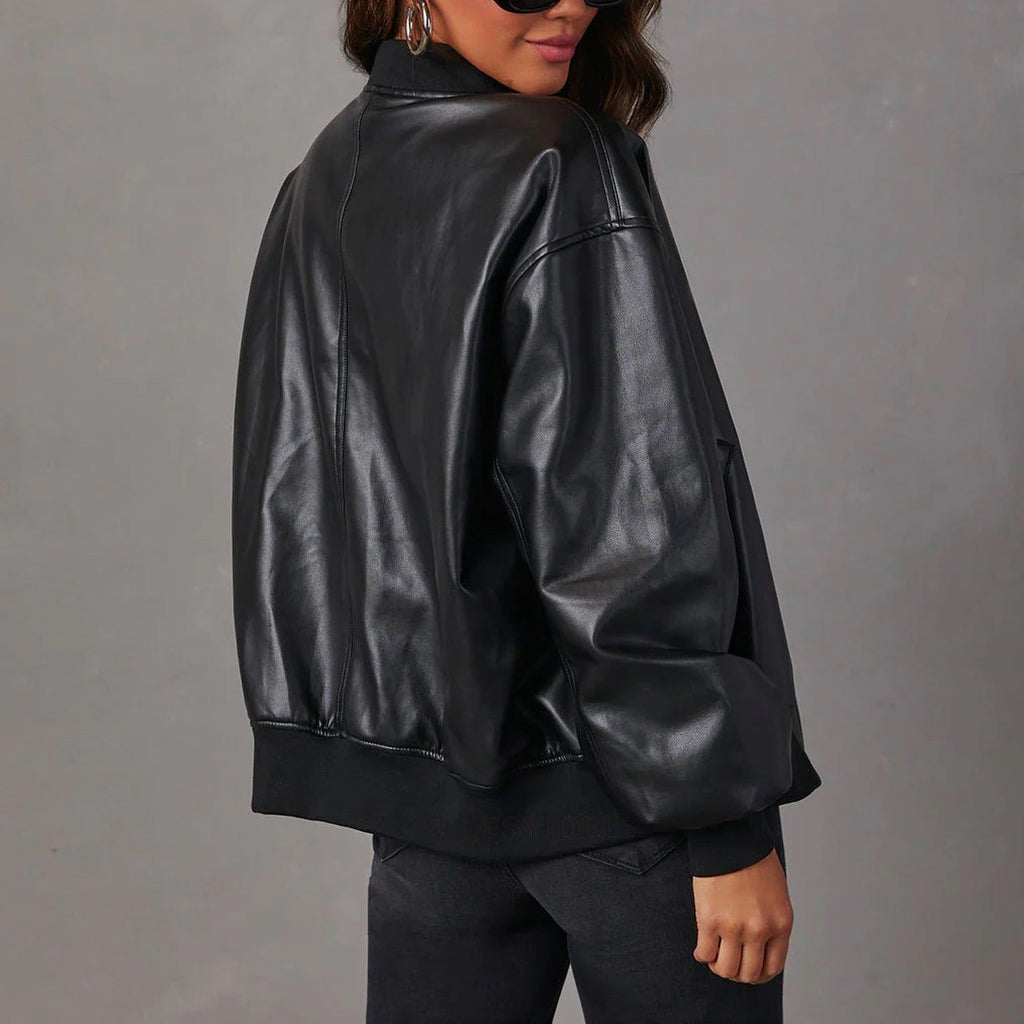 Woman wearing black leather jacket Jude with ribbed cuffs and hem, shown from back, paired with dark jeans and sunglasses
