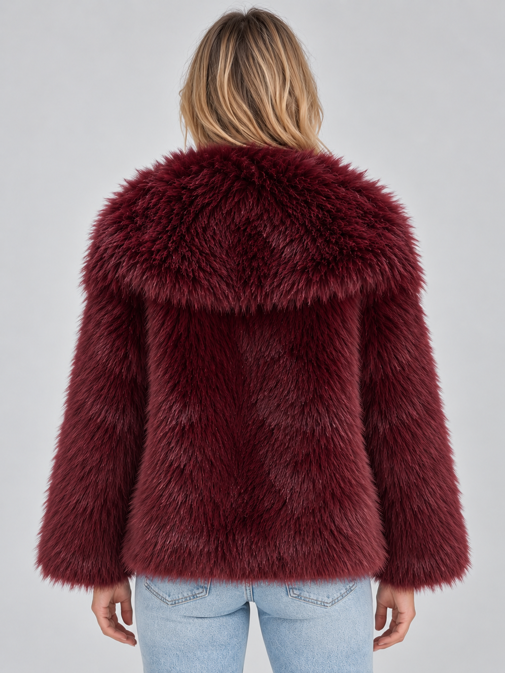 Woman wearing burgundy oversized faux fur winter coat with plush collar and long sleeves, viewed from back