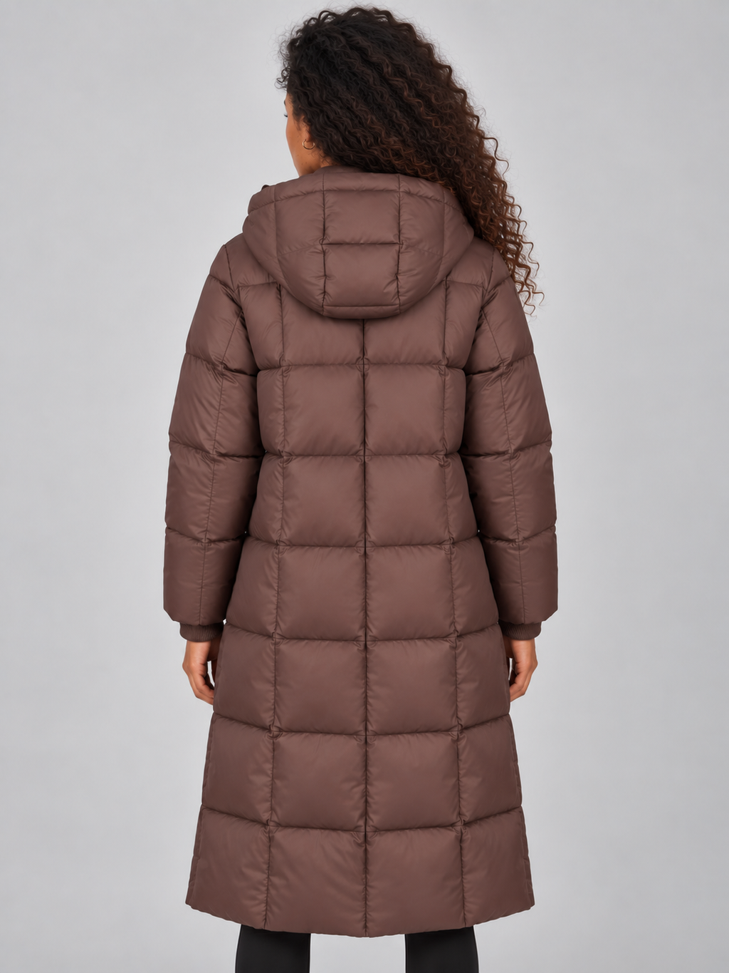 Woman wearing brown padded full zip hooded puffer winter jacket with quilted pattern, shown from back view
