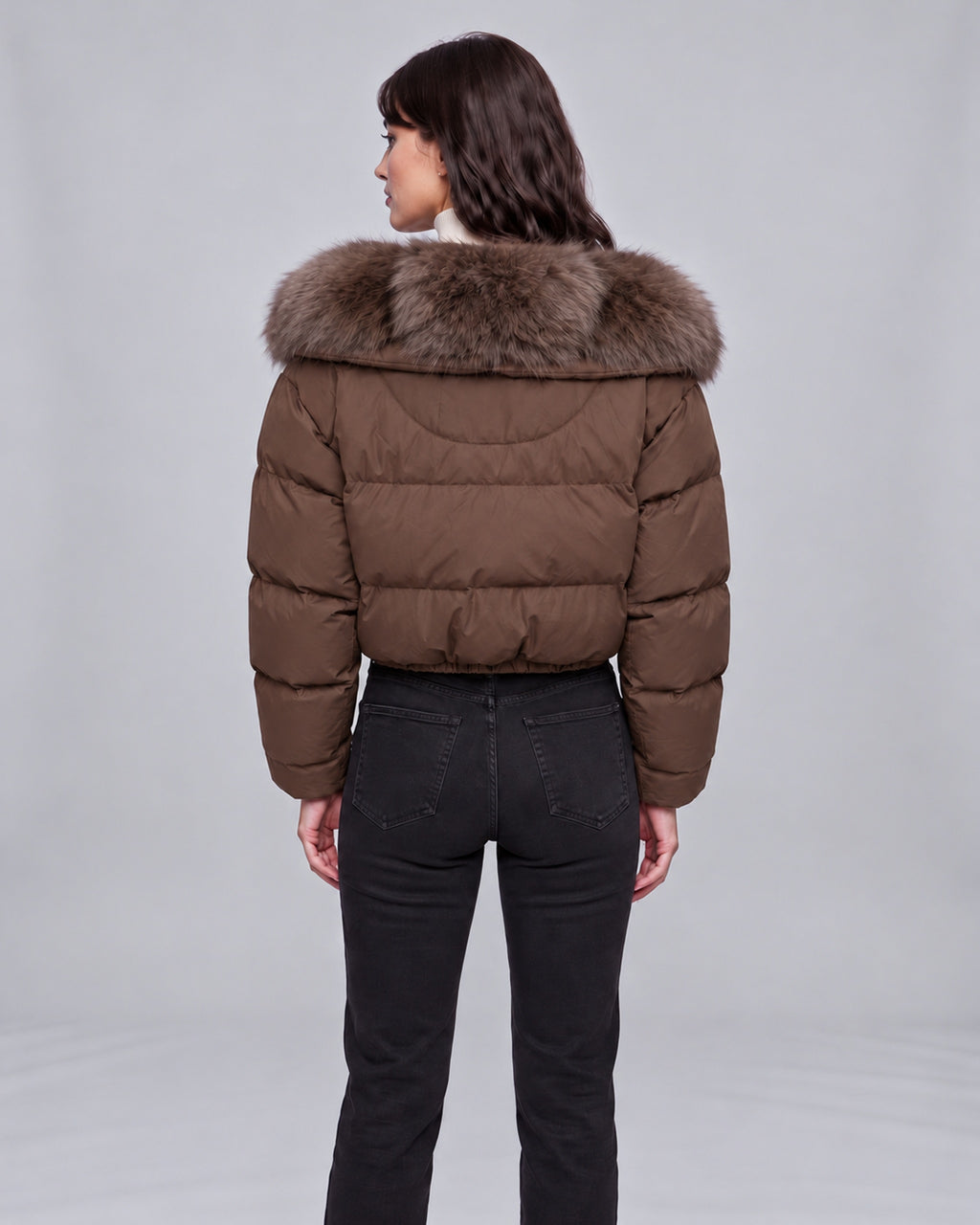Women’s brown cropped puffer jacket with fox fur-lined hood — back view on Jasmine