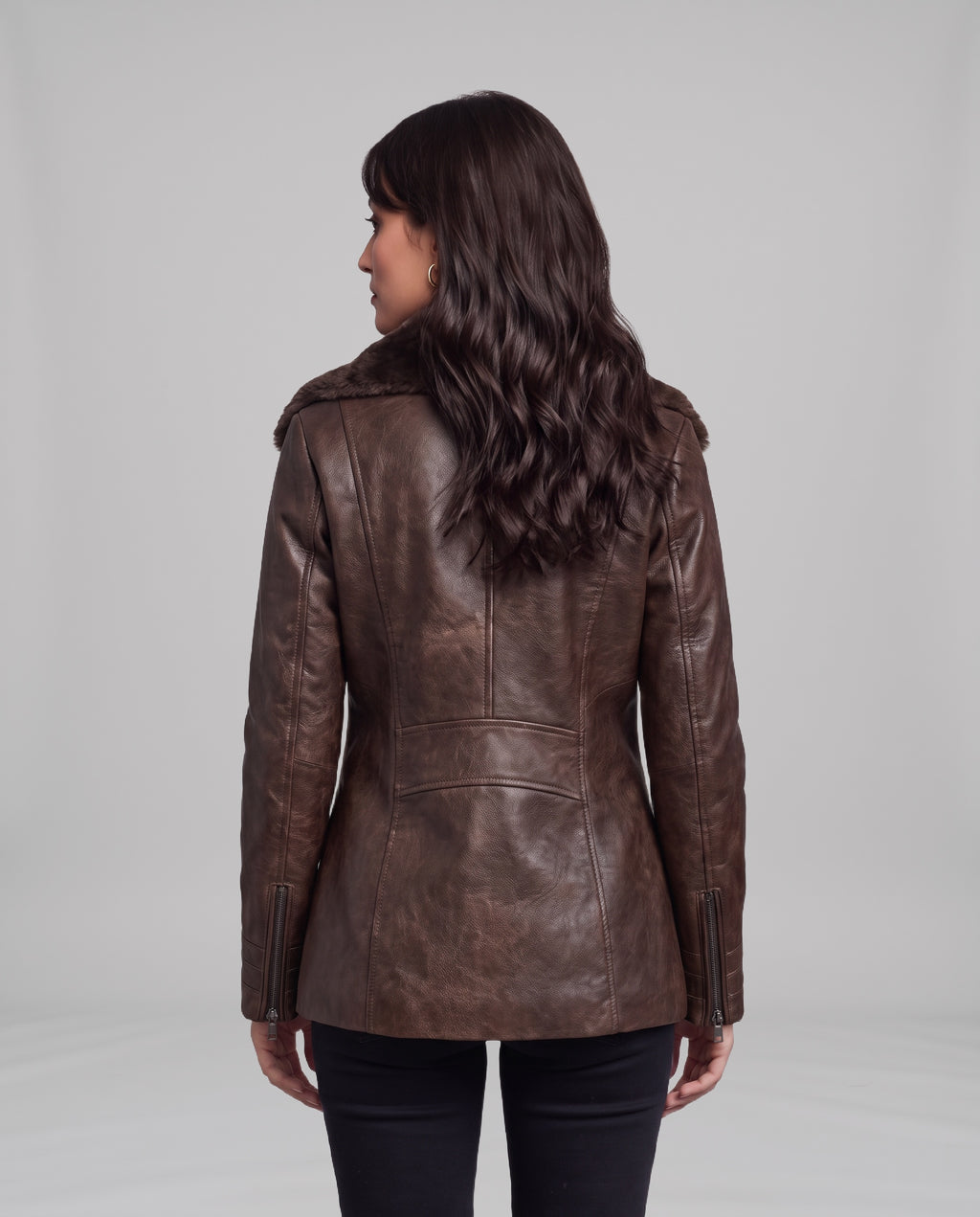 Back view of the Elegance shearling-lined leather jacket in brown showing centre-back seam, half-belt waist panel and cuff zips