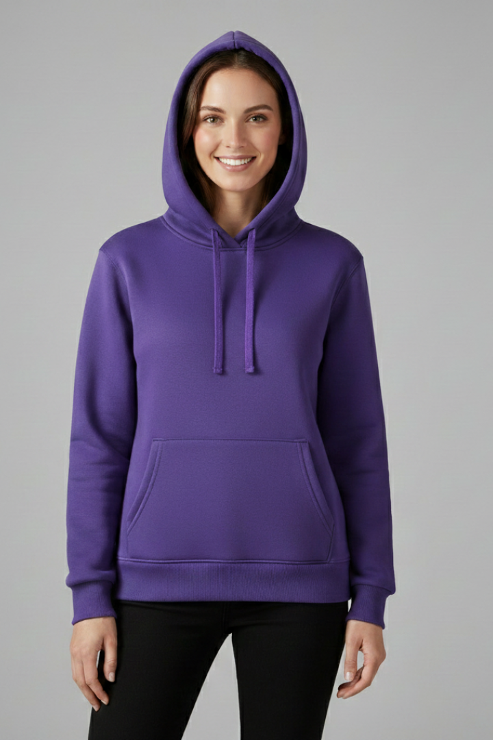 Woman wearing purple hoodie with adjustable drawstring hood and front pocket, paired with black pants
