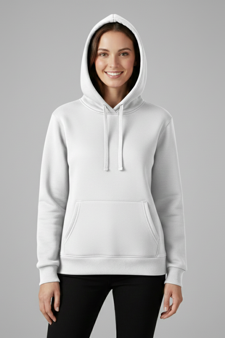 Woman wearing white pullover hoodie with adjustable drawstring hood, front pouch pocket, and ribbed hem, paired with black pants