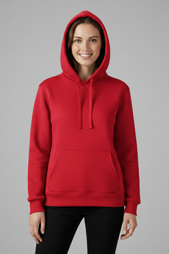 Woman wearing red Zephyr hoodie with adjustable hood and front pocket, paired with black pants against gray background