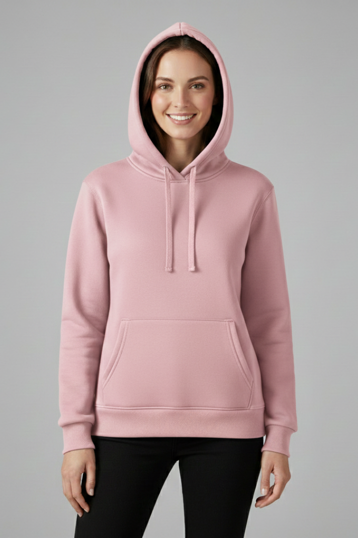 Woman wearing pink adjustable hood hoodie with front kangaroo pocket and ribbed hem, paired with black pants